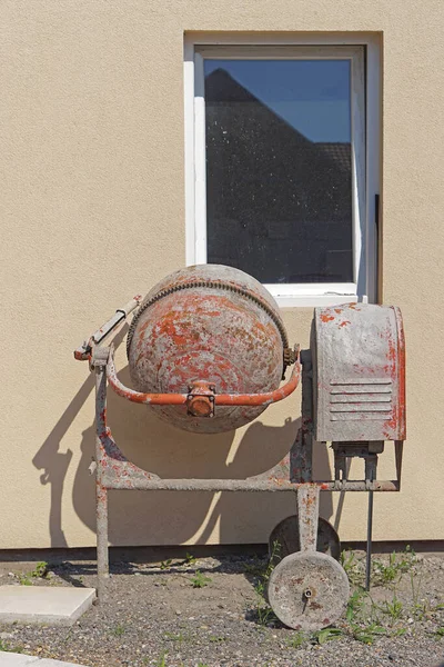 Gas powered concrete cement mixer near new house