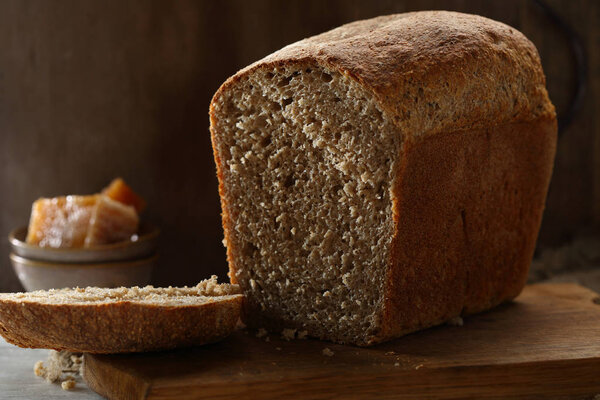 Loaf of brown bread with honey