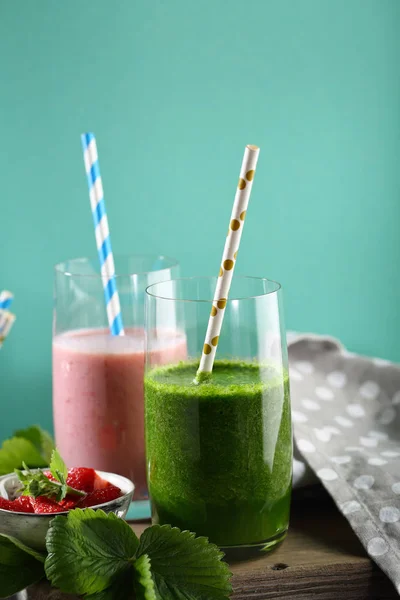 Set of summer smoothies on green background, beverages