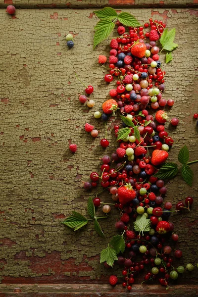 Wooden background with summer berries mix