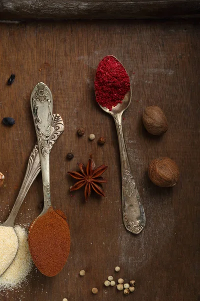 Spices powder on vintage spoons top view