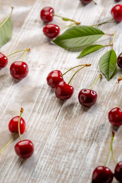 Fresh red cherry on white wood boards — Stock Photo, Image