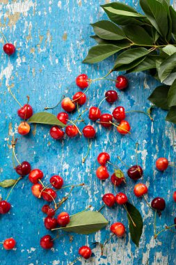 Ahşap mavi arka plan üzerinde taze kiraz