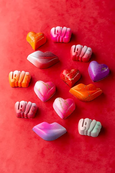 Delicious luxury candies on red — Stock Photo, Image