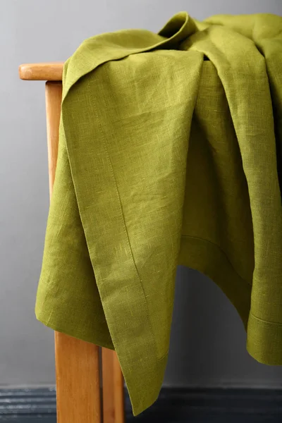 Green tables clothes on wood table — Stock Photo, Image