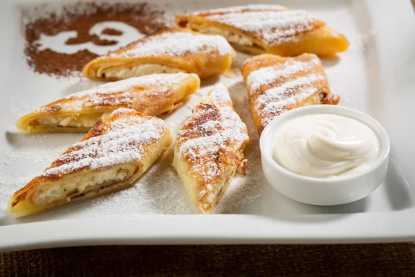 Crepes with cottage cheese and cream close-up — Stock Photo, Image