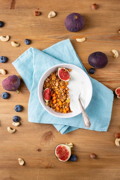 Granola  withfigs and yogurt on wooden table — Stock Photo, Image