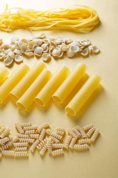 Uncooked Pasta Yellow Paper Background Food — Stock Photo, Image