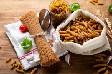 Tahta masada kepekli spagetti ve makarna.