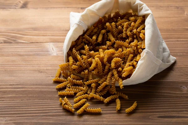 Whole Wheat Pasta Cotton Storage Bag Wooden Table — Stock Photo, Image