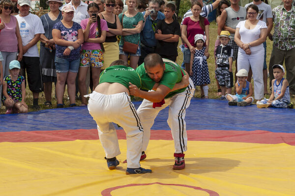 Ufa, Russia, July 9, 2016: the national wrestling kuresh at Sabantuy in the open field. Sabantuy is the annual national festival of the end of spring field work for the Tatars and Bashkirs.
