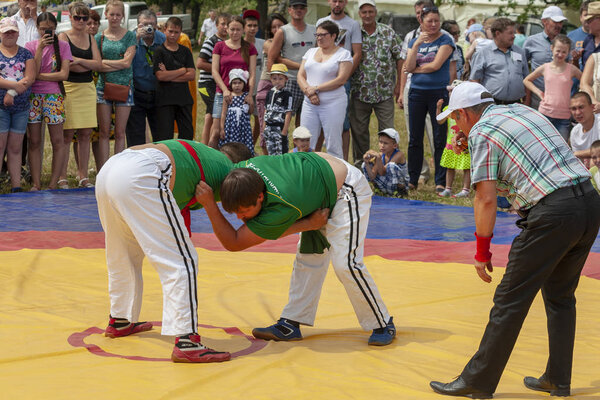 Ufa, Russia, July 9, 2016: the national wrestling kuresh at Sabantuy in the open field. Sabantuy is the annual national festival of the end of spring field work for the Tatars and Bashkirs.