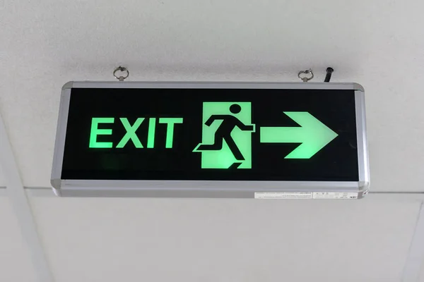 Fire exit sign at the corridor in building