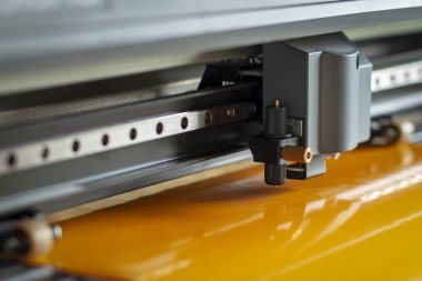 Kesici plotter yakın çekim. Bir vinil film kesme işlemi.