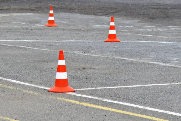 Bright road cones on the asphalt