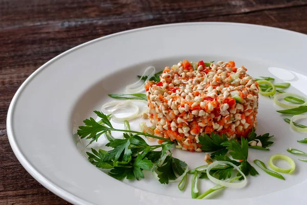 Vegetarian dish: salad of sprouted buckwheat seeds with cucumber