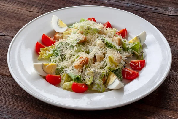 Vegetarian dish. Caesar salad with eggs, parmesan, cherry tomatoes and garlic toasts.