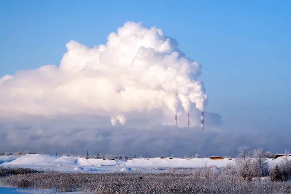 Pipes of thermal power plants emit thick smoke. Thermal power plants in thick fog. Probable air pollution.