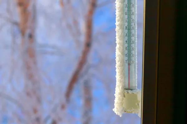 Classic mercury thermometer for measuring ambient temperature, hanging outside the window, with readings minus 70 degrees Celsius. Minus 70 degrees below zero.