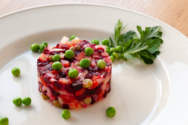 Vegetarian dish. Vinaigrette of avocado, carrots, beets, sauerkraut, green peas and vegetable oil.