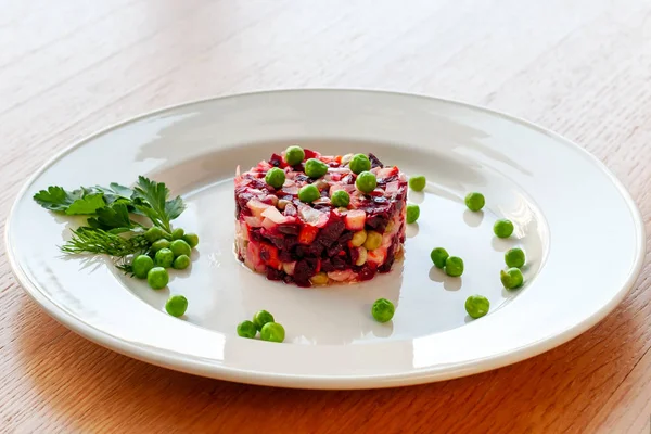 Vegetarian dish. Vinaigrette of avocado, carrots, beets, sauerkraut, green peas and vegetable oil. General view.
