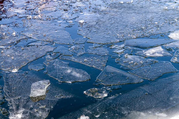 Broken ice on the water surface in spring.