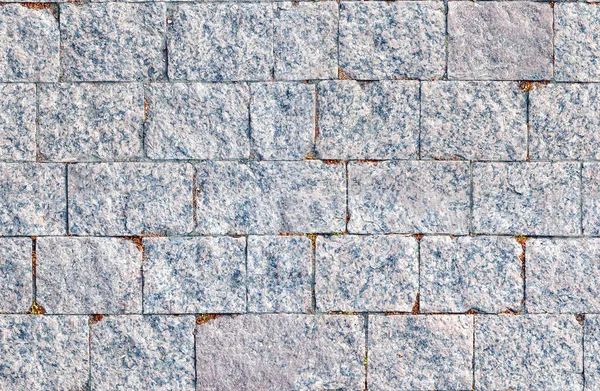 De textuur van de klinkers gemaakt van grijze steen. Stenen achtergrond. — Stockfoto