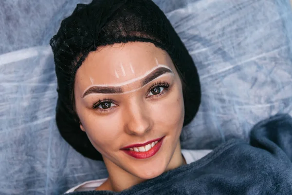 model with drawings on the face before surgery