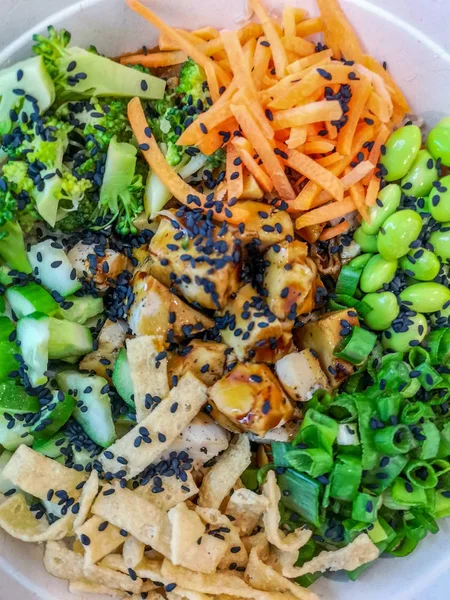 Chicken and veggie salad bowl with cucumber, carrot, broccoli, spring onion, green beans