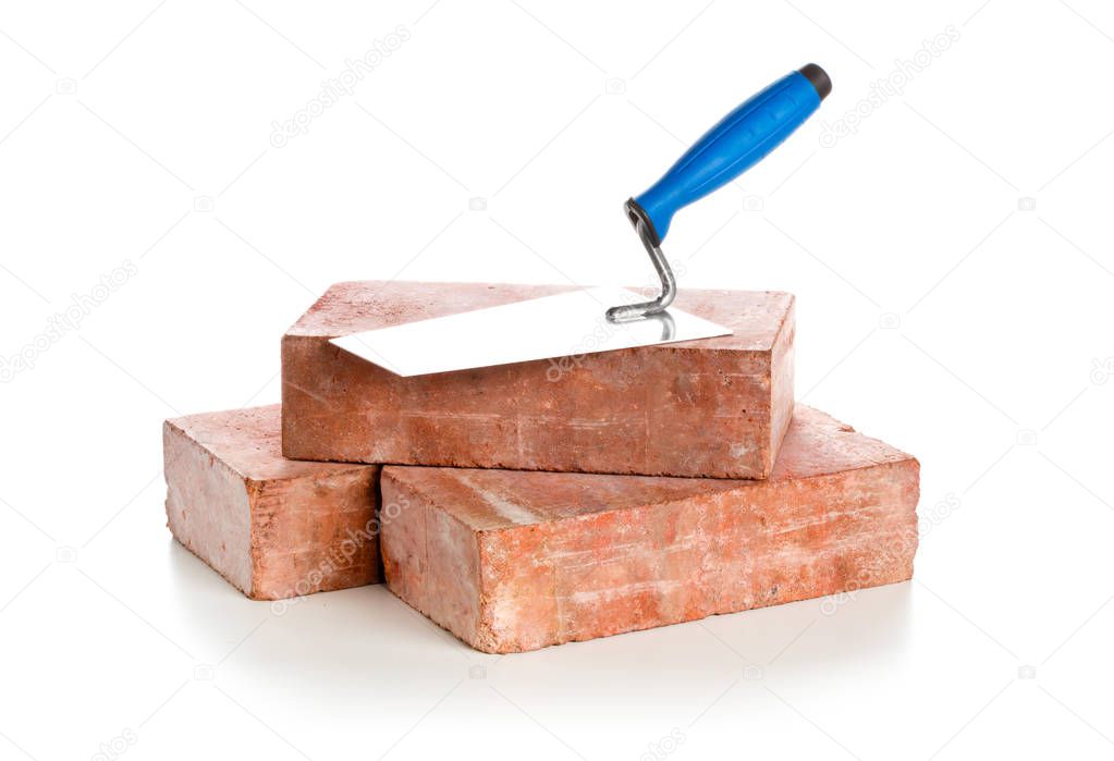 Trowel with bricks on white background - home construction or renovation concept