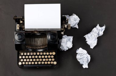 Boş, boş bir kağıt yaprağına ve siyah arka plan üzerine ufalanmış Kağıt topları ile yukarıdan Vintage daktilo yukarıdan aşağıya flatlay vurdu