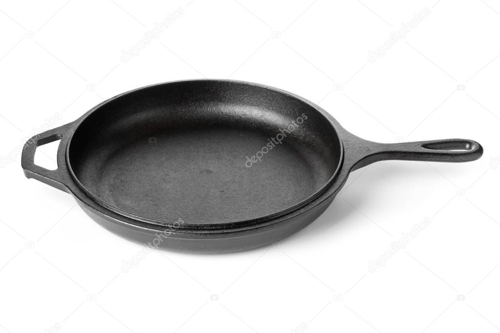 Empty, clean black cast iron pan or dutch oven over white background