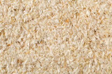 Yukarıdan doku arka plan düz doldurarak isabgol çerçeve olarak da adlandırılan psyllium kabuğu yatıyordu. İsabgol olarak da bilinir psyllium kabuğu Hindistan'da bulunan dar ovata bitkisinin tohumlarından elde edilen lif olduğunu. Yukarıdan düz yatıyordu.