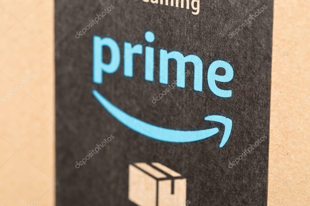 DRESDEN, GERMANY - APRIL 3, 2019 : Close up of Amazon Prime logo on tape of delivered parcel. Prime is a service offered by online retailer Amazon for faster delivery of orders. Selective focus.