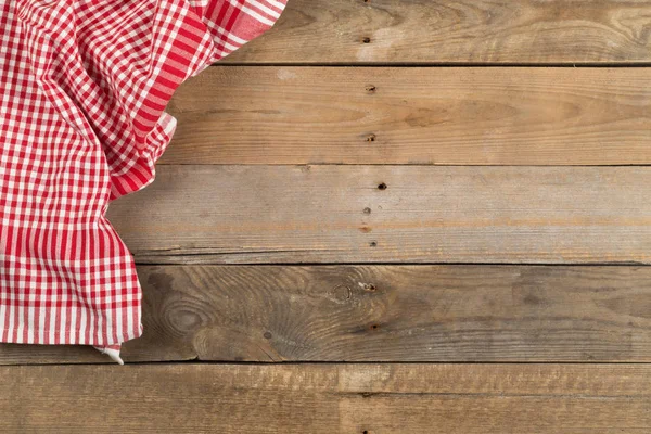 Stoffa rossa a quadretti su tavola in legno rustico marrone piatto — Foto Stock