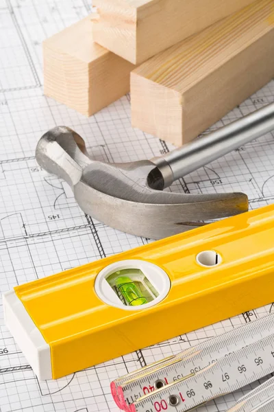 Construction tools and wooden strips on architectural blueprint — Stock Photo, Image