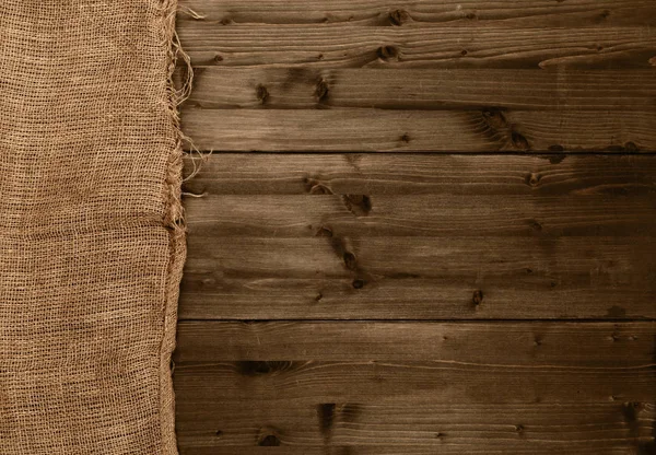 Tkanina burlap tkaniny na brązowy drewniany stół kuchenny z miejsce — Zdjęcie stockowe