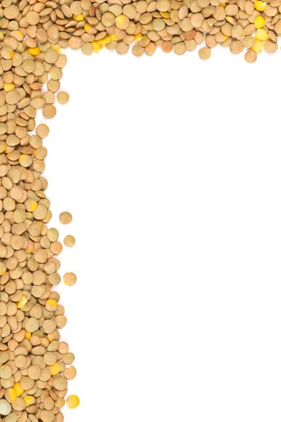 Raw, dry, uncooked brown lentil legumes frame border texture bac — Stock Photo, Image