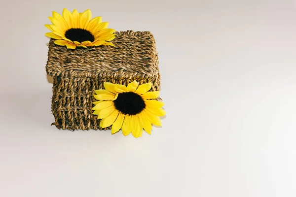 Brown wicker basket decorated with yellow flowers — Stock Photo, Image