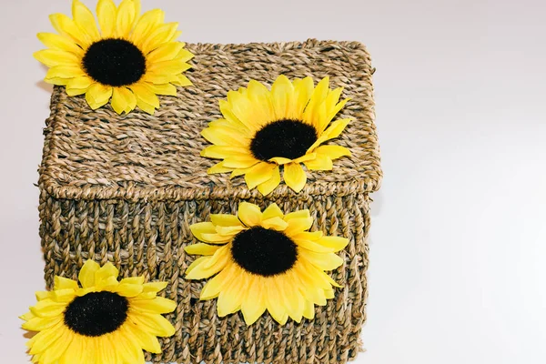 Brown wicker basket decorated with yellow flowers — Stock Photo, Image