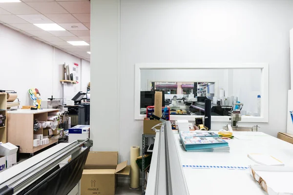 Work area in paper cutting workshop with material and machines — Stock Photo, Image