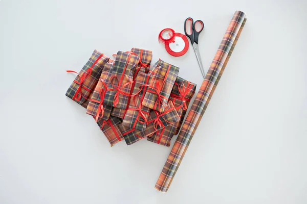 Envoltura de regalo sobre un fondo claro. Papel, cinta adhesiva, tijeras . — Foto de Stock