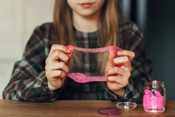 Dítě drží hračku zvané hlenu, dítě baví a experimentování. — Stock fotografie