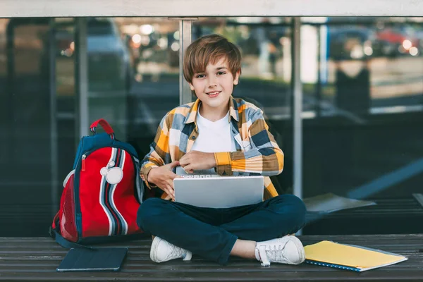 Menino Bonito Uma Camisa Xadrez Está Sentado Banco Com Laptop — Fotografia de Stock