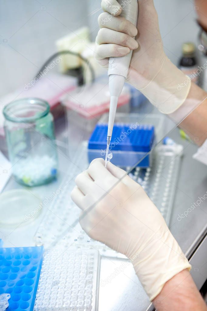 a laboratory specialist takes a sample to study the composition, close-up