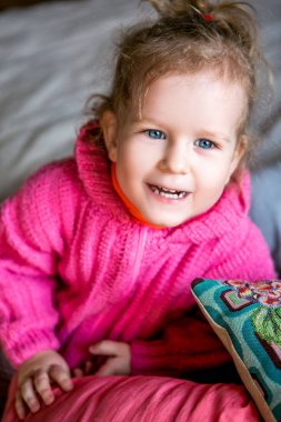 mavi gözlü sevimli kız pembe kazaklı güler