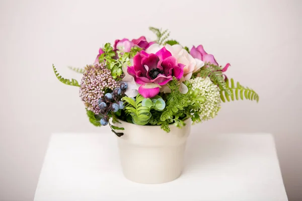 Bouquet of beautiful mixed flowers in vase. Lovely bunch of flowers. Work of the professional florist. Wedding or home decor