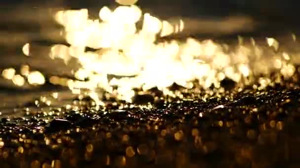 Reflection of sunrise on the stones and sand on the beach Turkey — Stock Video