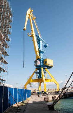 Mavi gökyüzü arka planında sarı iskele vinci