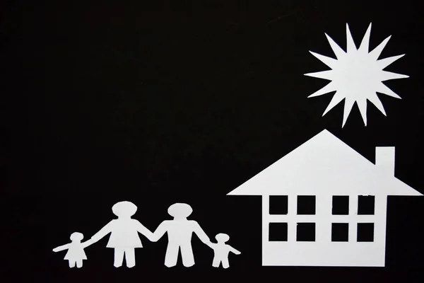 concept image of make your a house. Paper cut of family with house and tree